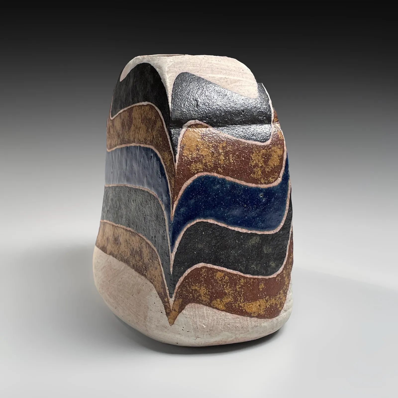 KAMODA SHŌJI, Standing flattened, rounded rectangular vessel decorated with colored, curvaceous bands in light brown, ochre yellow, cream and blue overglaze enamel, 1975