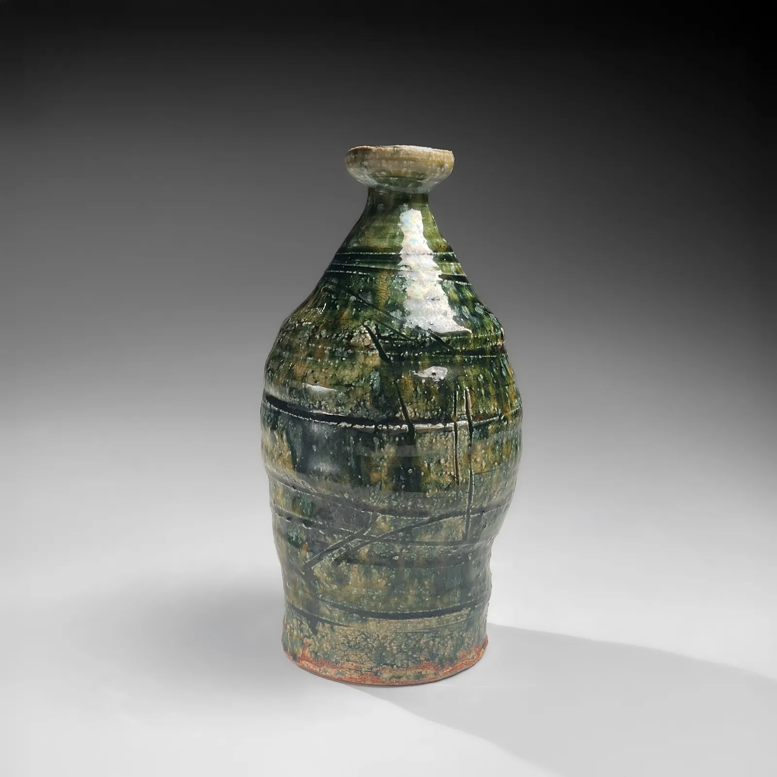 OKABE MINEO, Oribe-glazed vase with narrow neck, flaring mouth, and carved banding, 1955