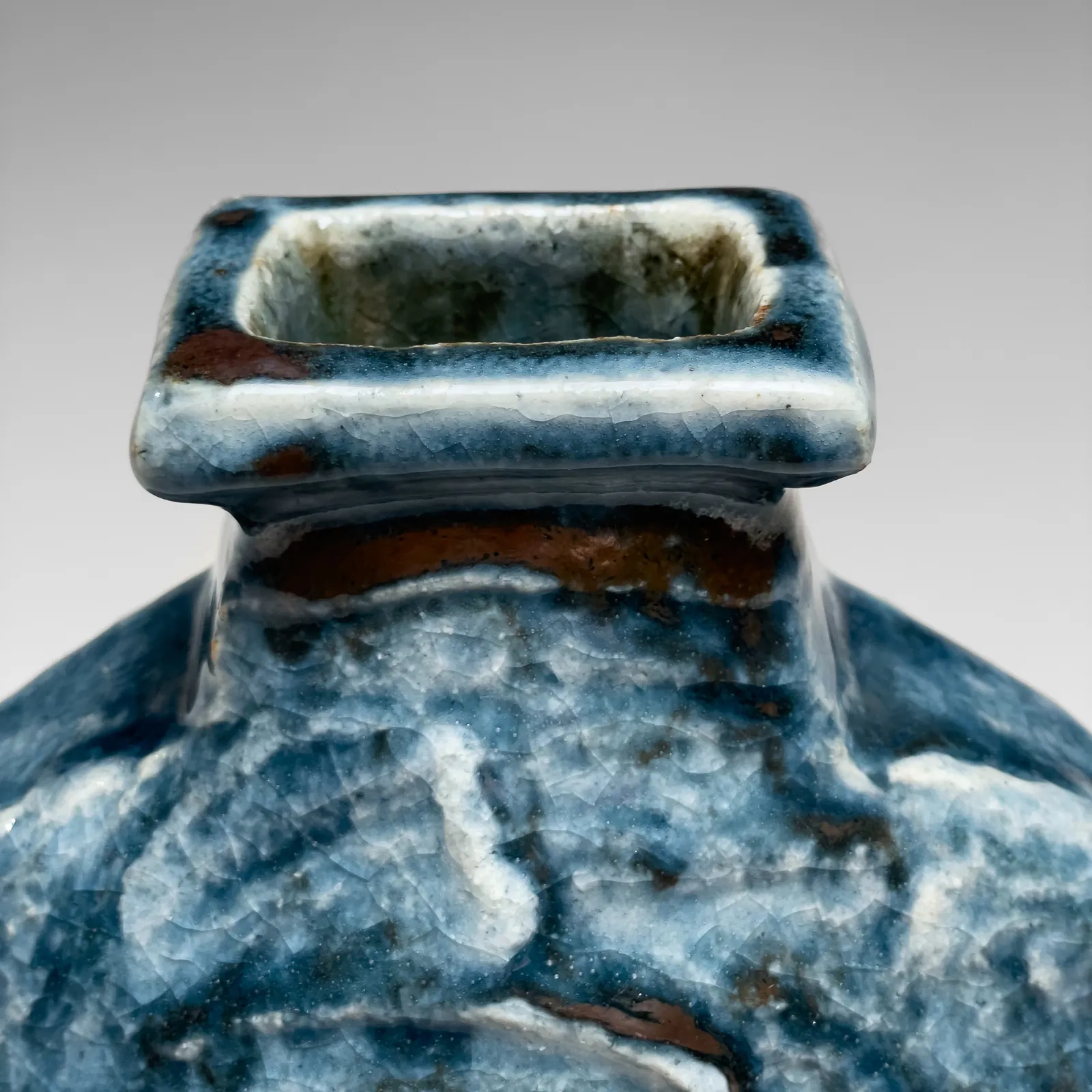KAWAI KANJIRŌ, Cobalt-glazed (gosu) flattened circular vessel with raised rectangular mouth and carved decoration, ca. 1950s-60s