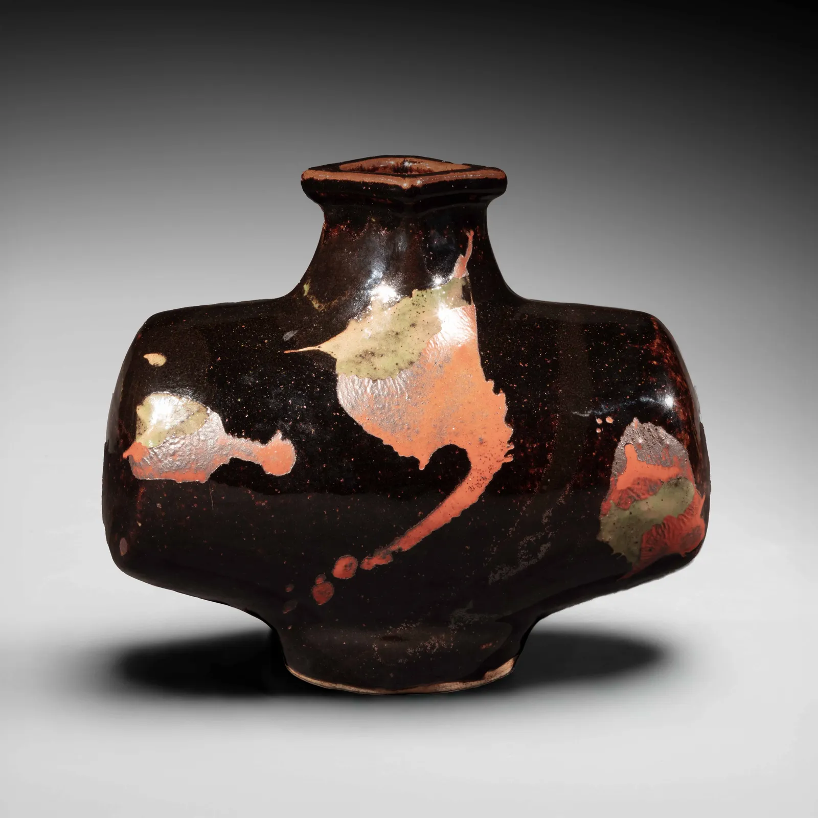KAWAI KANJIRŌ, Black barrel-shaped vessel with splashed patterning in red and green, ca. 1960