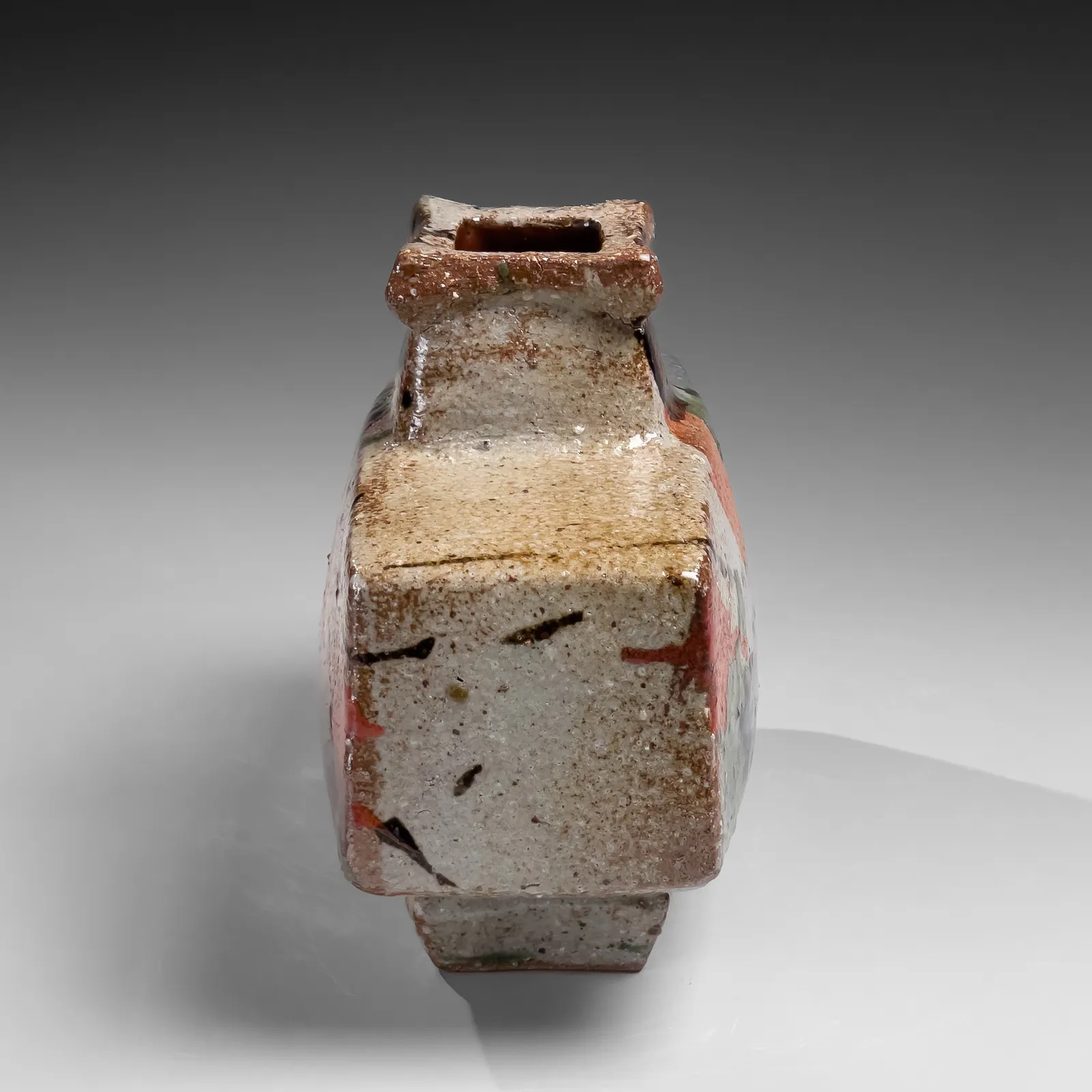 KAWAI KANJIRŌ, Flattened wide rectangular vessel with raised mouth decorated with sançai glazing, ca. 1960