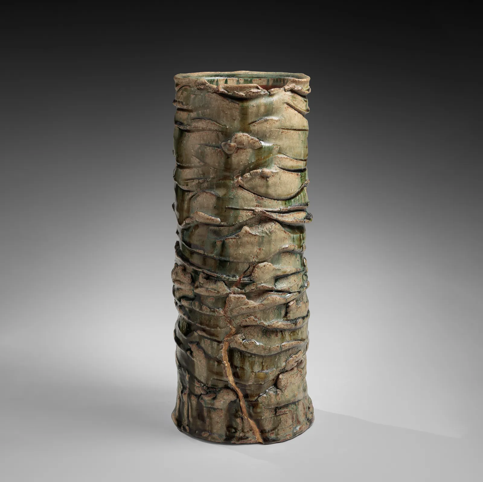 OKABE MINEO, Tall Oribe-glazed columnar vessel with irregular carved bands, 1967