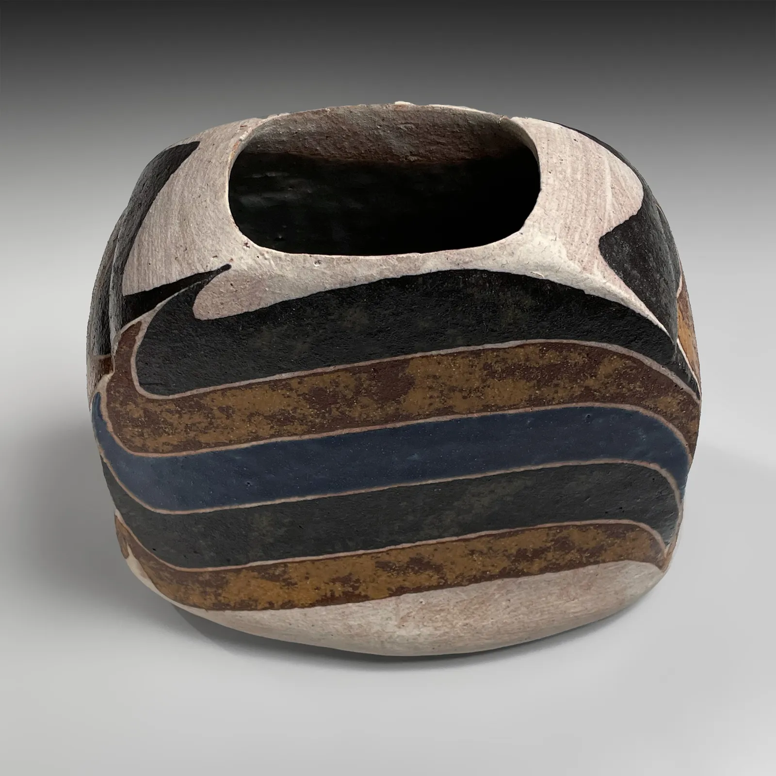 KAMODA SHŌJI, Standing flattened, rounded rectangular vessel decorated with colored, curvaceous bands in light brown, ochre yellow, cream and blue overglaze enamel, 1975