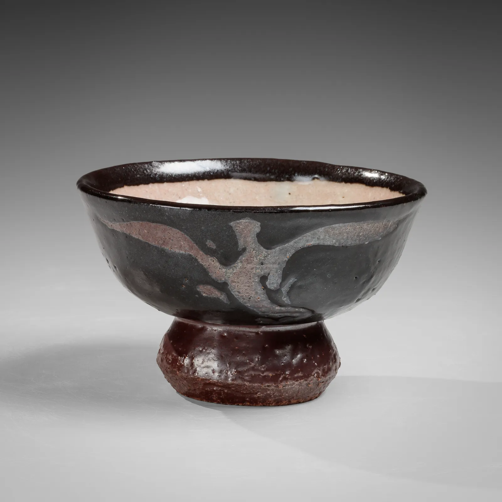 KAWAI KANJIRŌ, Black teabowl with raised foot and masked phoenix and dragon motifs, ca. 1938