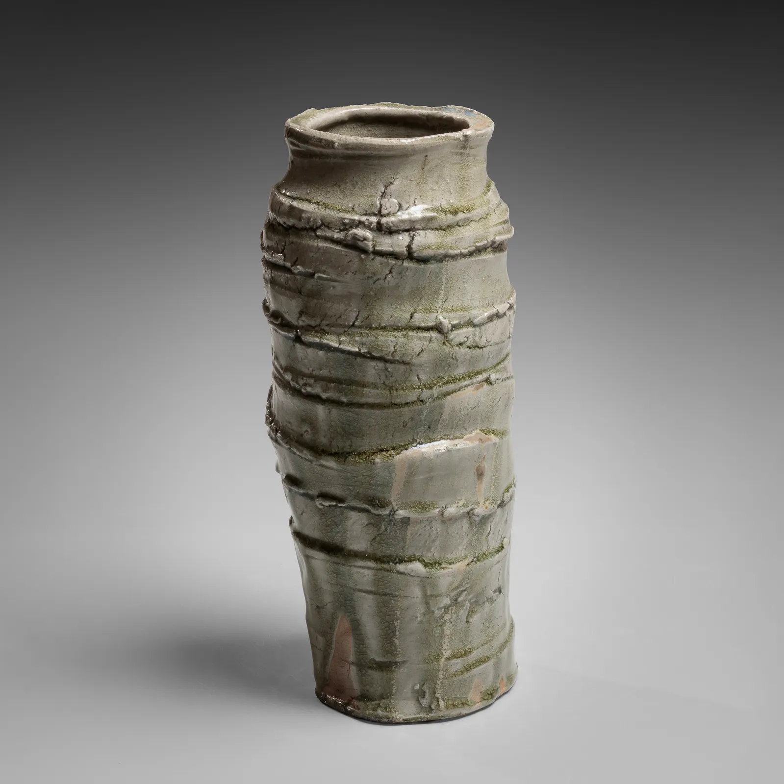 OKABE MINEO, Ash-glazed columnar vessel with irregular carved banding, 1963