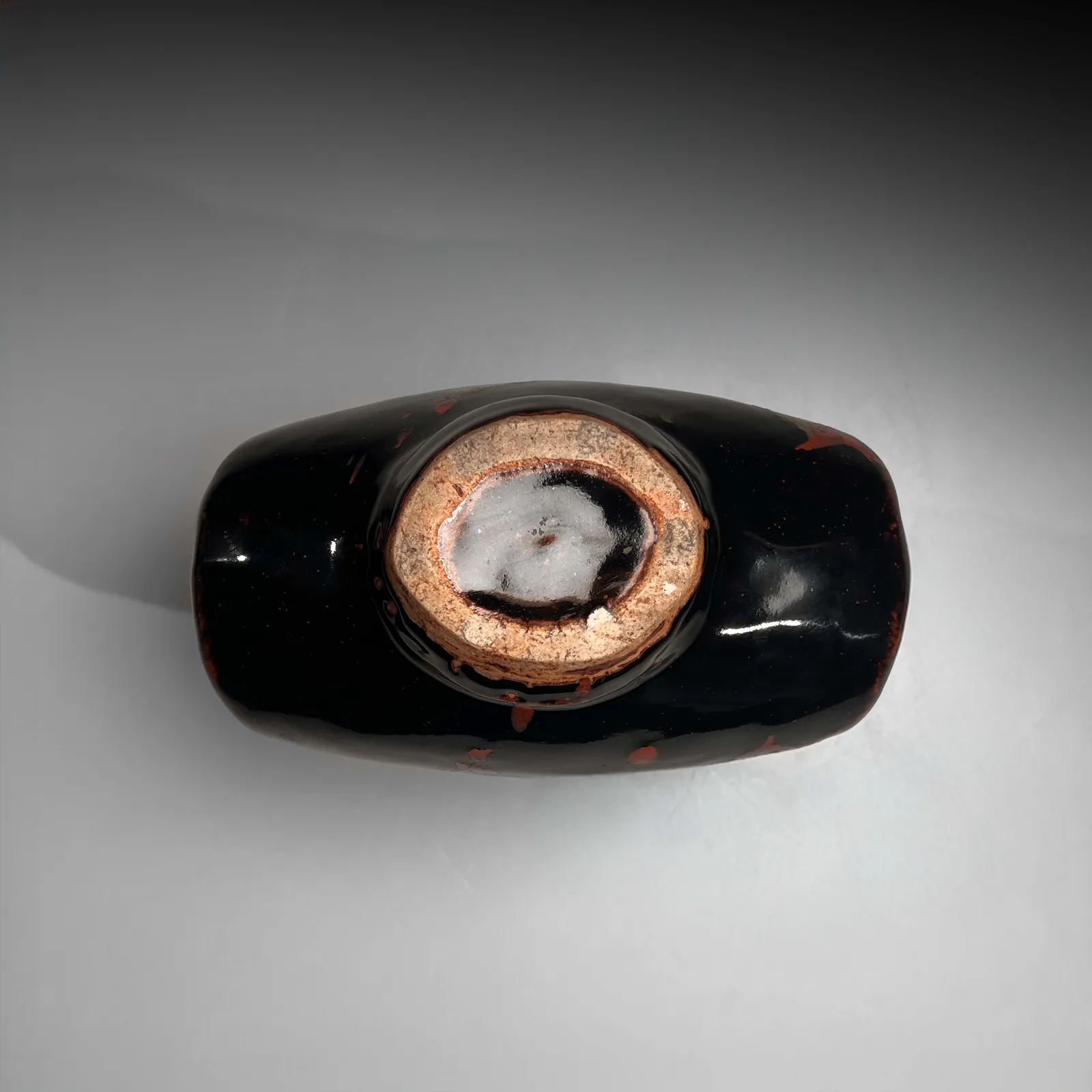 KAWAI KANJIRŌ, Black barrel-shaped vessel with splashed patterning in red and green, ca. 1960