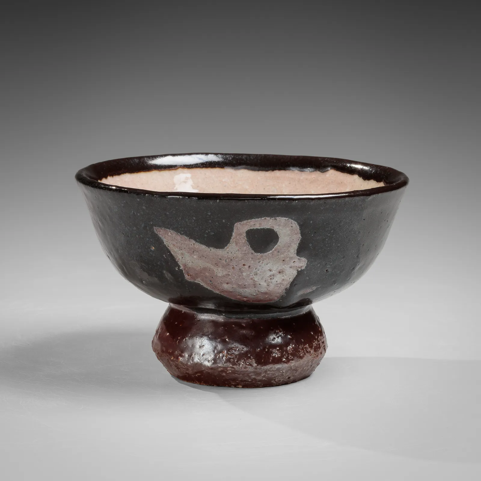 KAWAI KANJIRŌ, Black teabowl with raised foot and masked phoenix and dragon motifs, ca. 1938