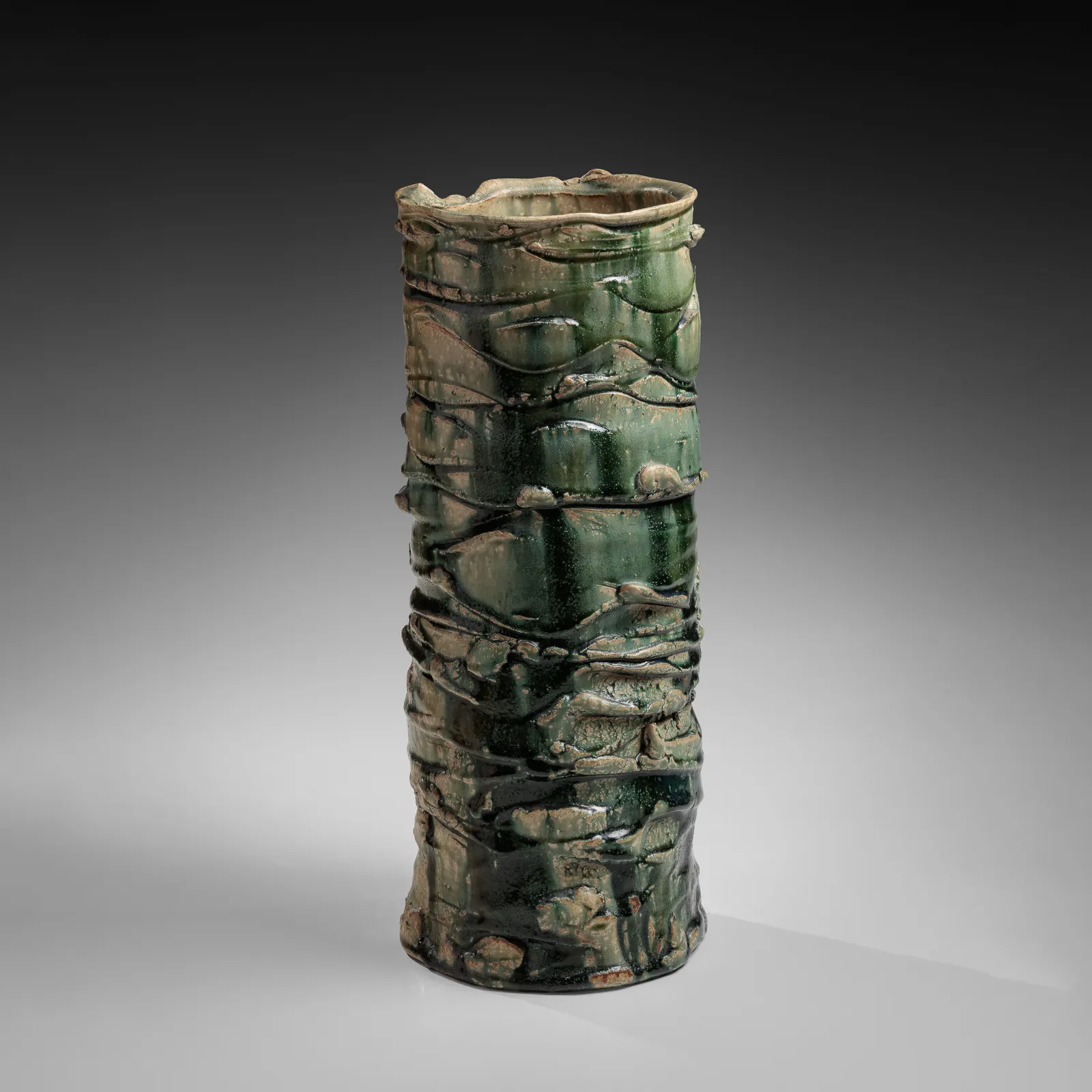 OKABE MINEO, Tall Oribe-glazed columnar vessel with irregular carved bands, 1967