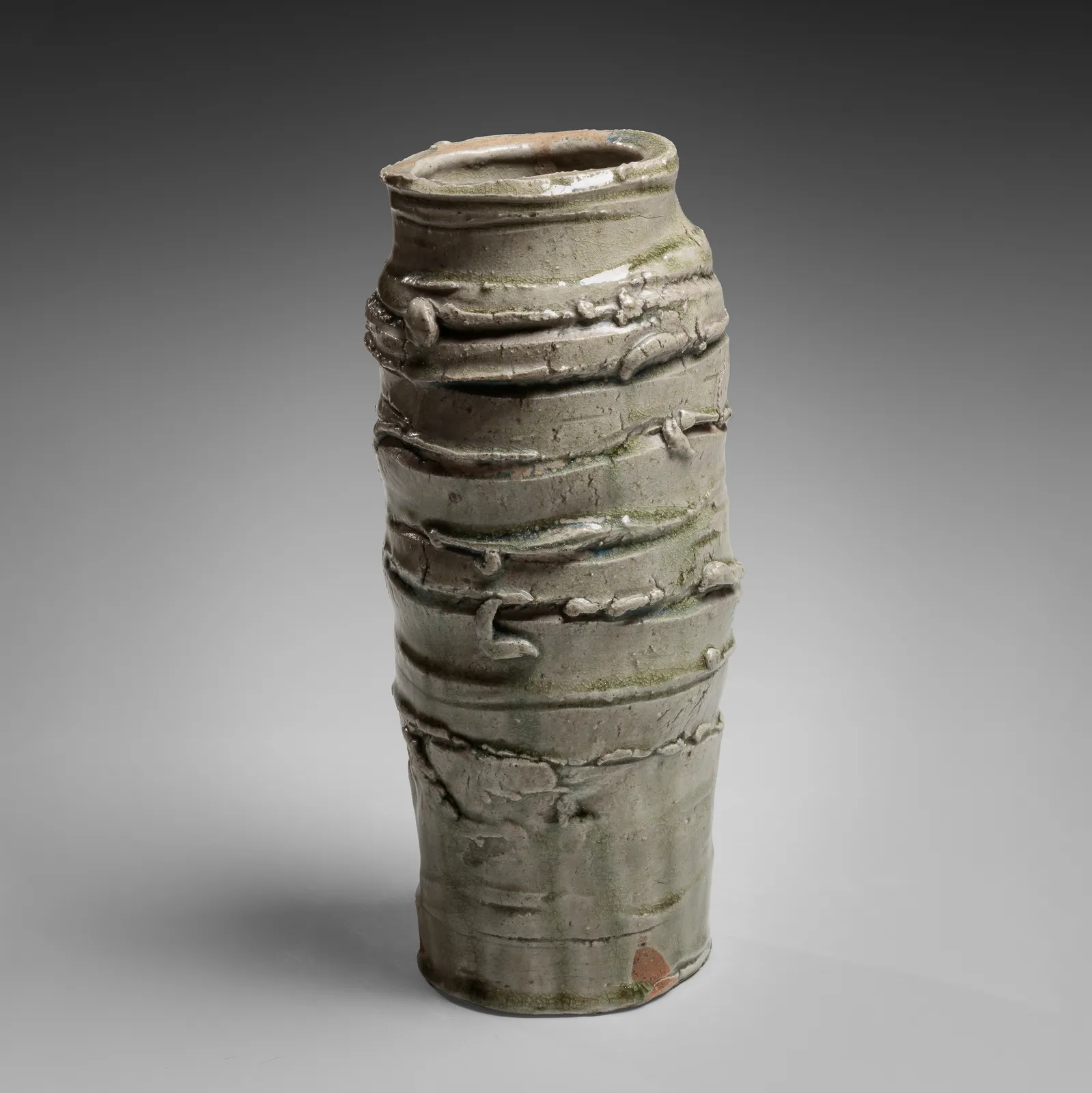 OKABE MINEO, Ash-glazed columnar vessel with irregular carved banding, 1963