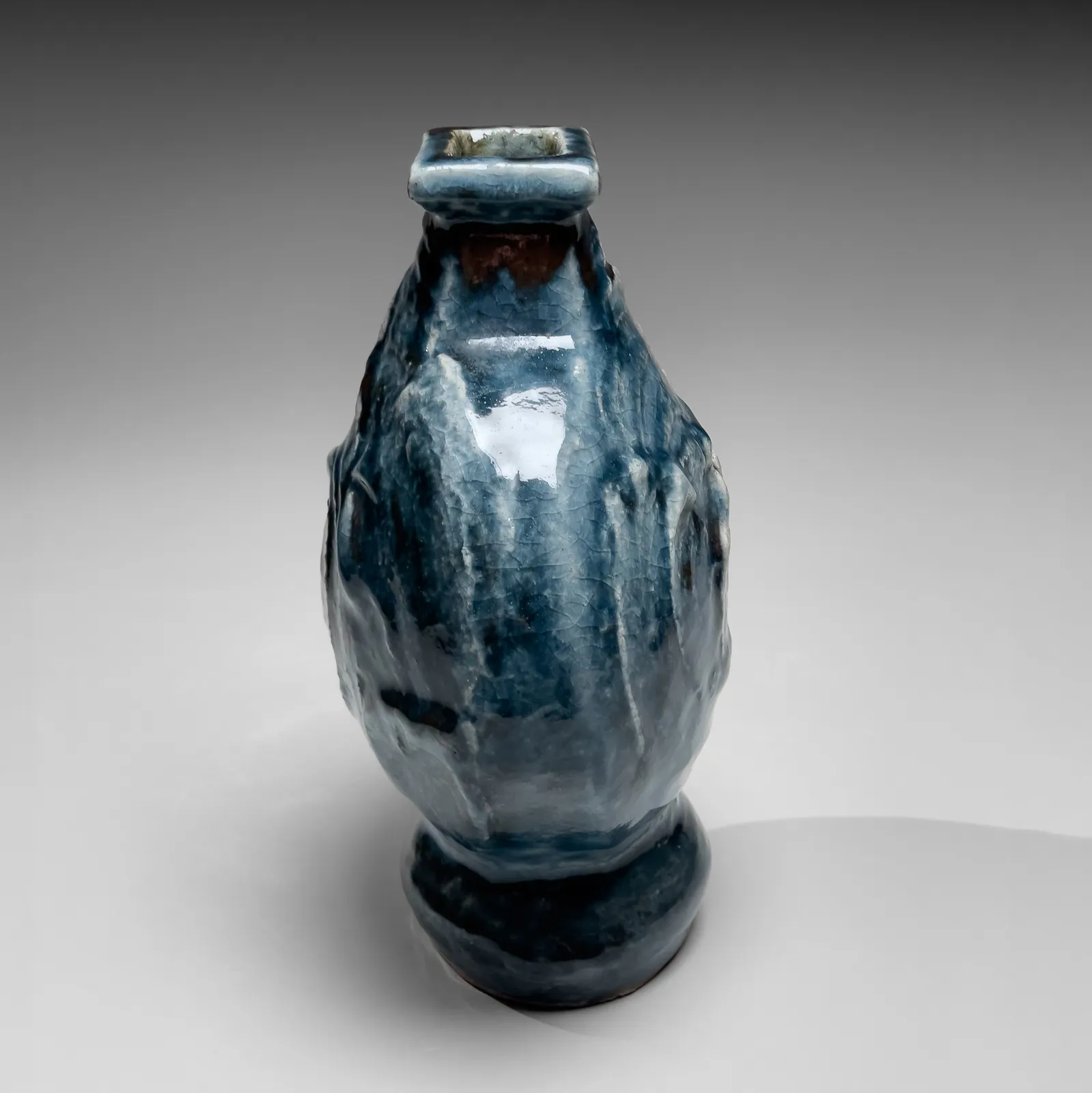 KAWAI KANJIRŌ, Cobalt-glazed (gosu) flattened circular vessel with raised rectangular mouth and carved decoration, ca. 1950s-60s
