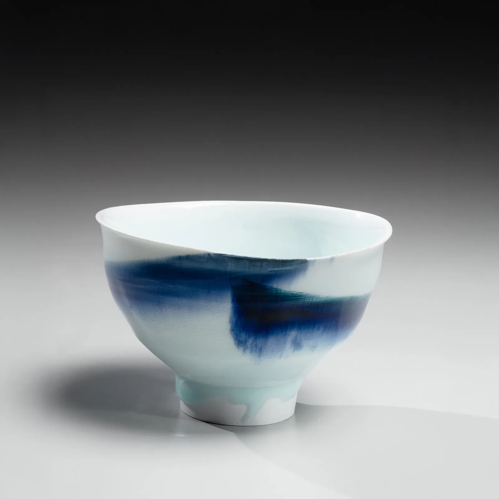 KATŌ TSUBUSA, Conical teabowl on high narrow foot with sometsuke (blue underglaze) decoration and dripping seihakuji (bluish-white) celadon glaze, 2001
