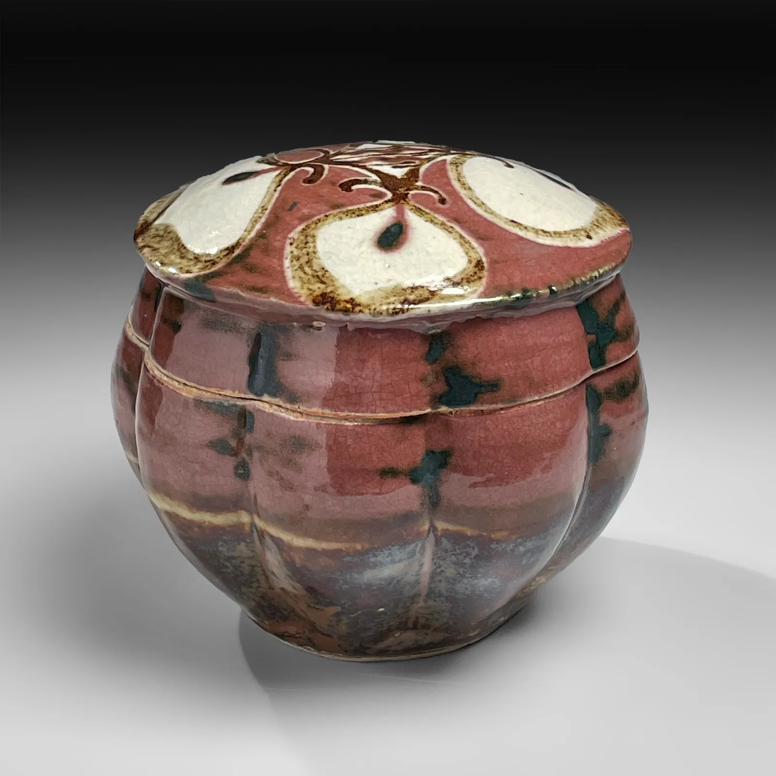 KAWAI KANJIRŌ, Red copper-glazed, lobed, covered box with floral design, ca. 1950