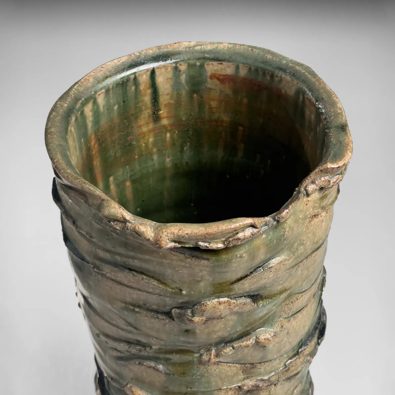 OKABE MINEO, Tall Oribe-glazed columnar vessel with irregular carved bands, 1967