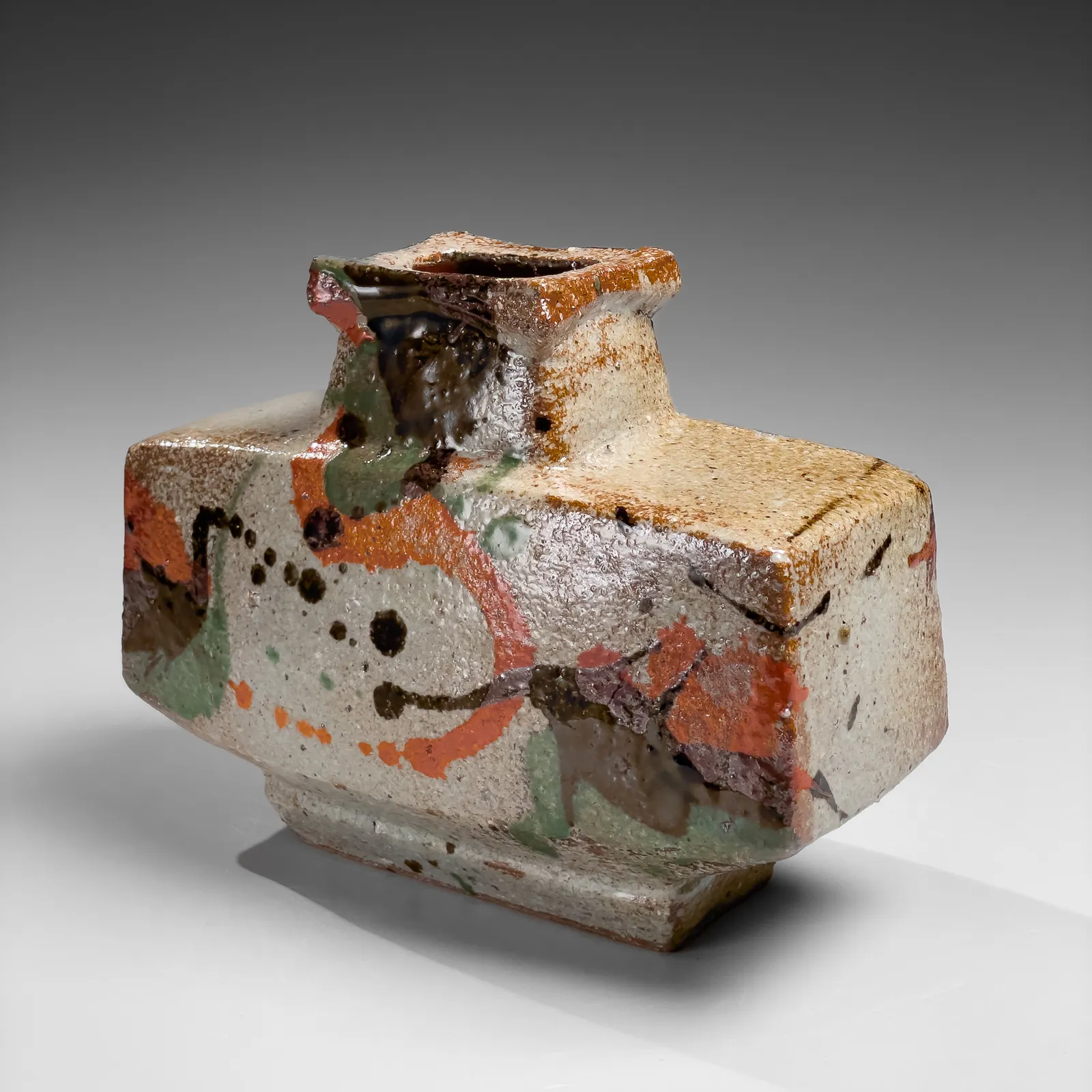 KAWAI KANJIRŌ, Flattened wide rectangular vessel with raised mouth decorated with sançai glazing, ca. 1960