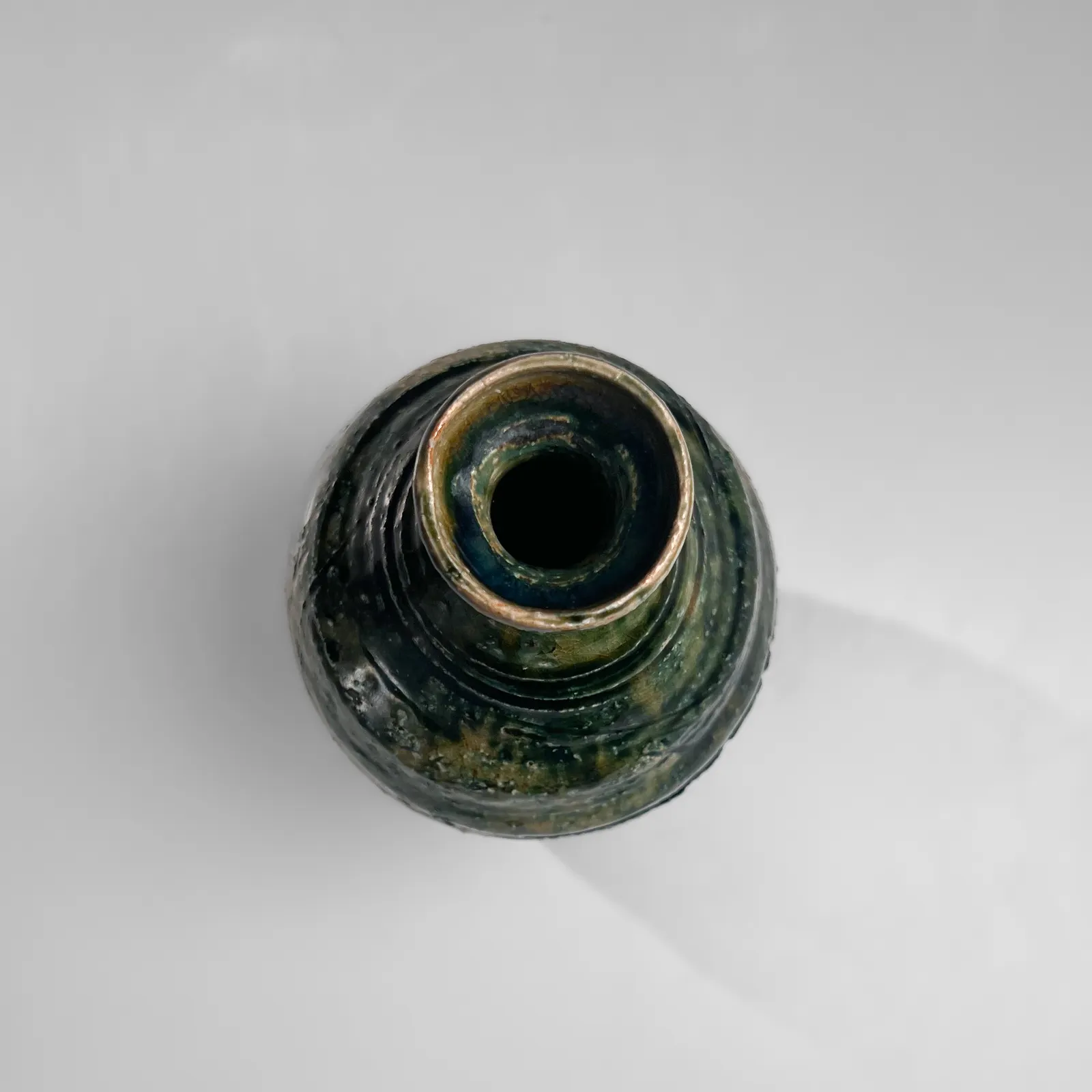 OKABE MINEO, Oribe-glazed vase with narrow neck, flaring mouth, and carved banding, 1955