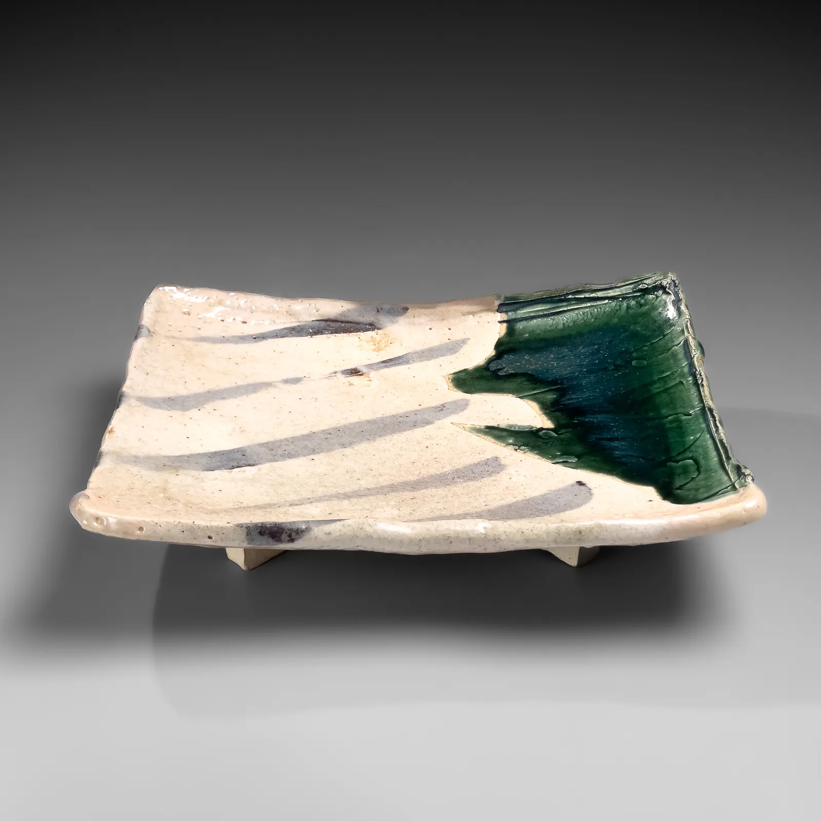 OKABE MINEO, Shino and Oribe-glazed rectangular platter with four feet, 1965