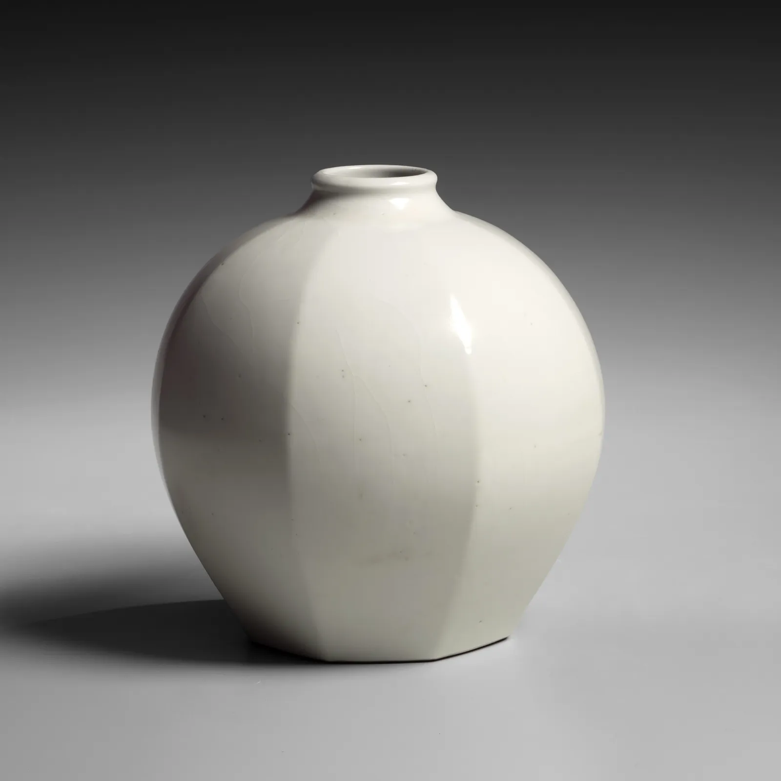 TOMIMOTO KENKICHI, Faceted white porcelain vessel with narrow, upraised neck, 1932