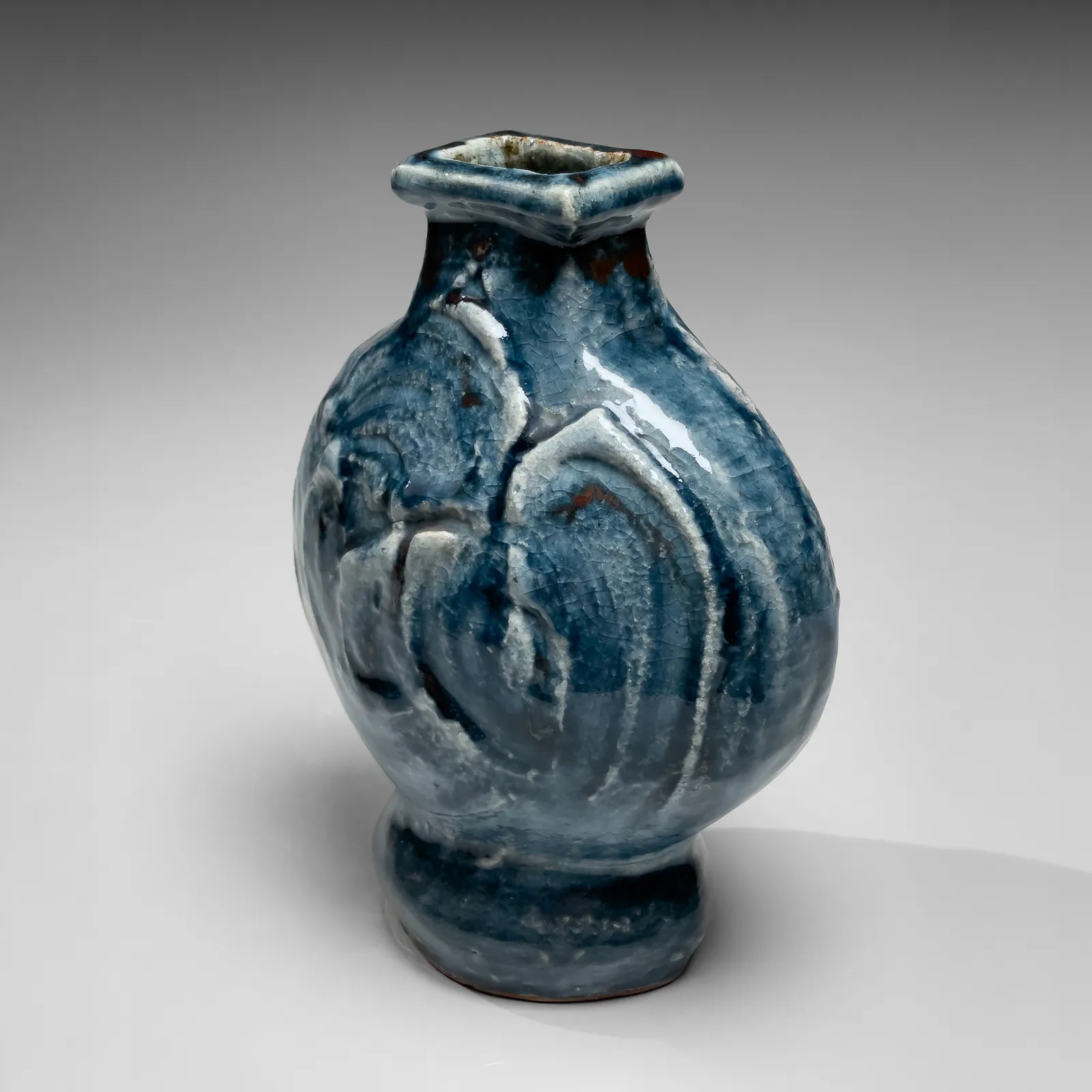 KAWAI KANJIRŌ, Cobalt-glazed (gosu) flattened circular vessel with raised rectangular mouth and carved decoration, ca. 1950s-60s