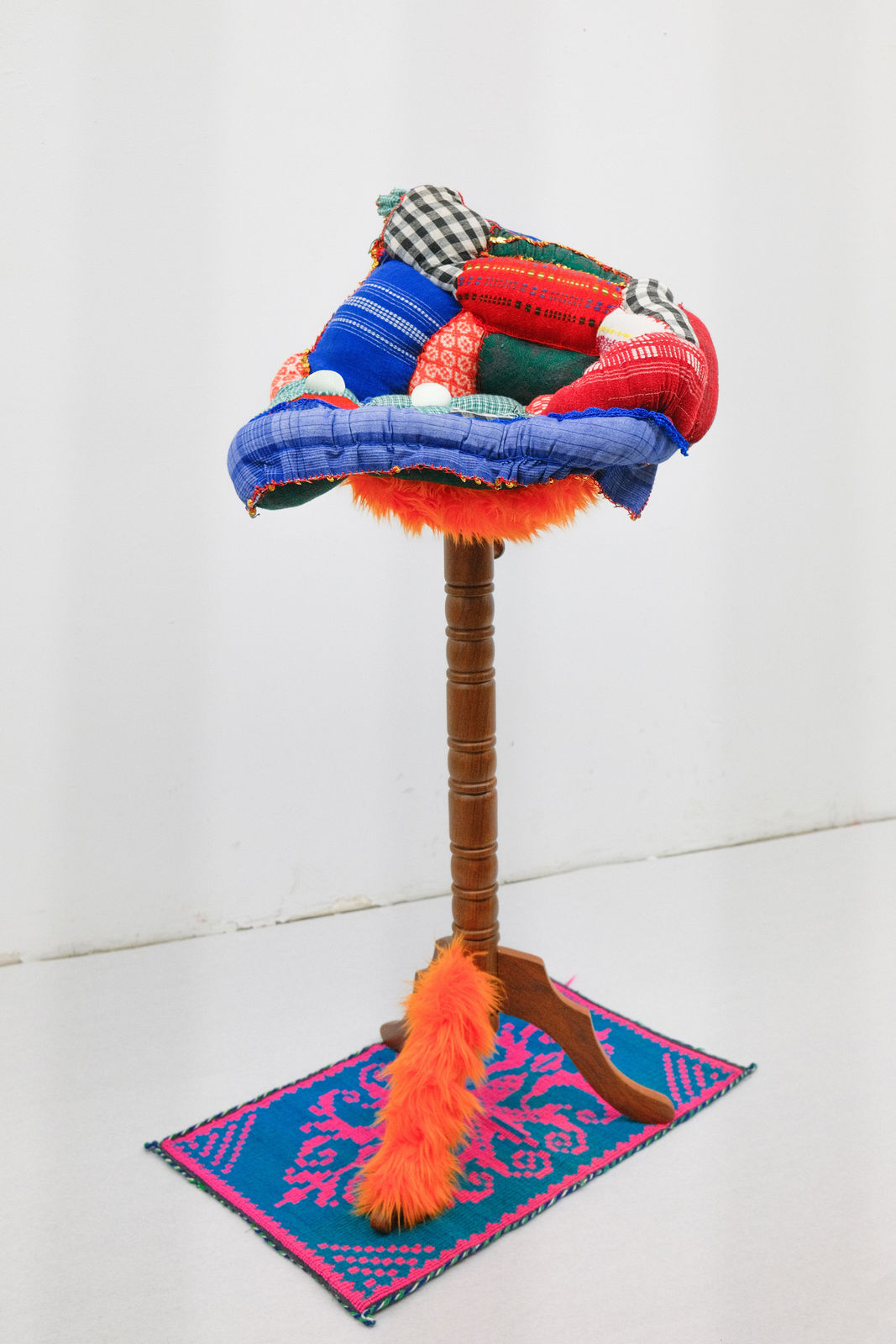 PRAYER. PATTERN. PRAYER, Lilian Shtereva sitting on a stump with a pillow sham, near the shrub roses - close to home, 2024