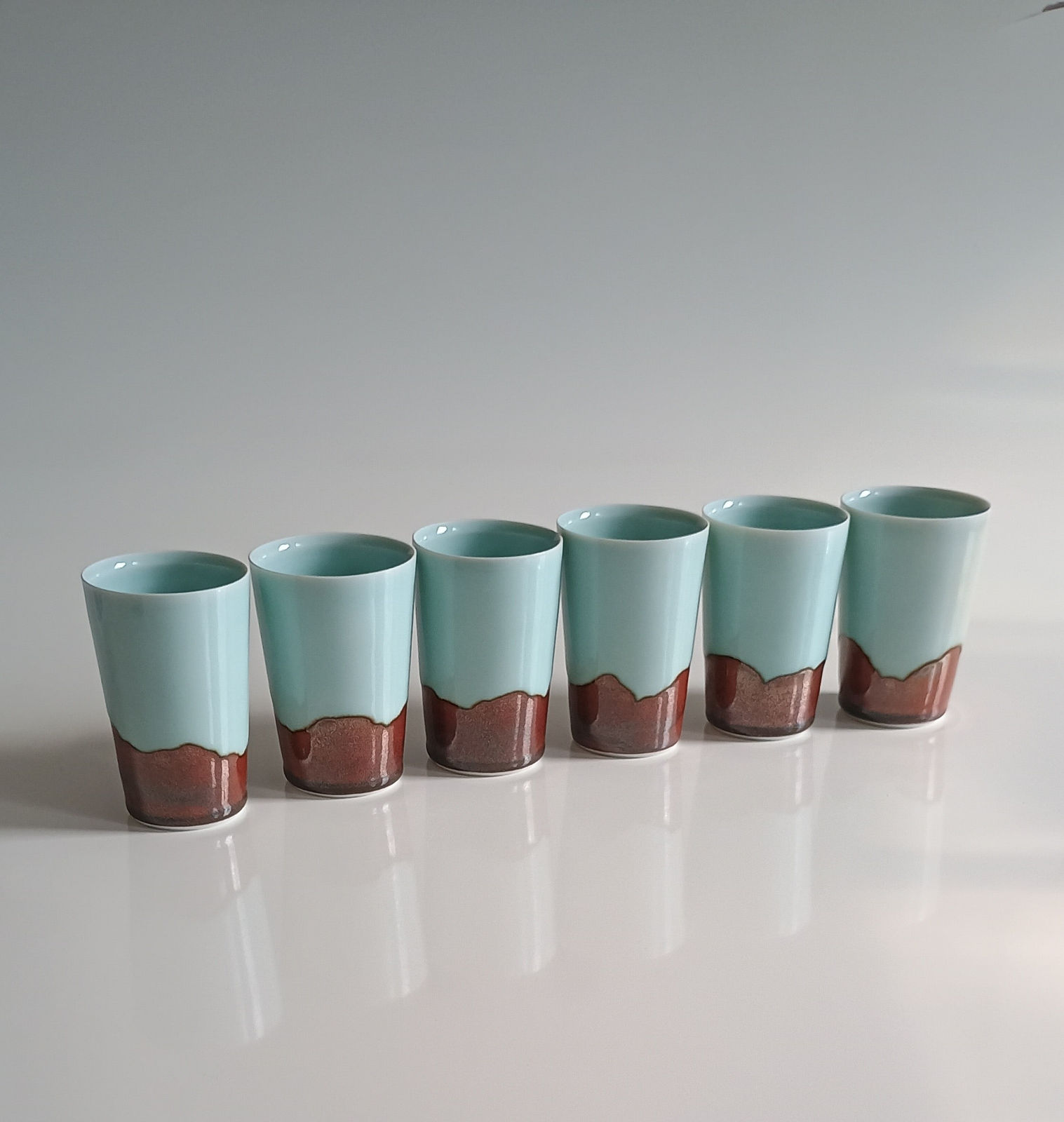Chris Keenan, Celadon Beakers with Red Horizon, 2025