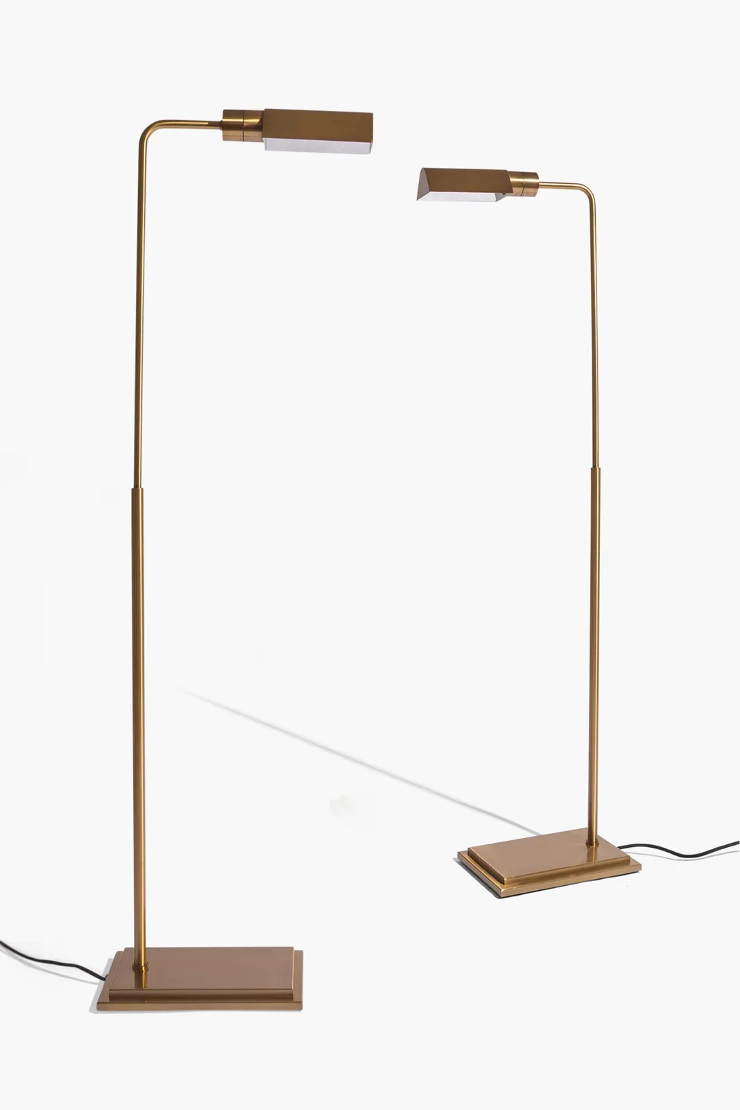 A pair of vintage aged brass reading lights in the style of Cedric Hartman