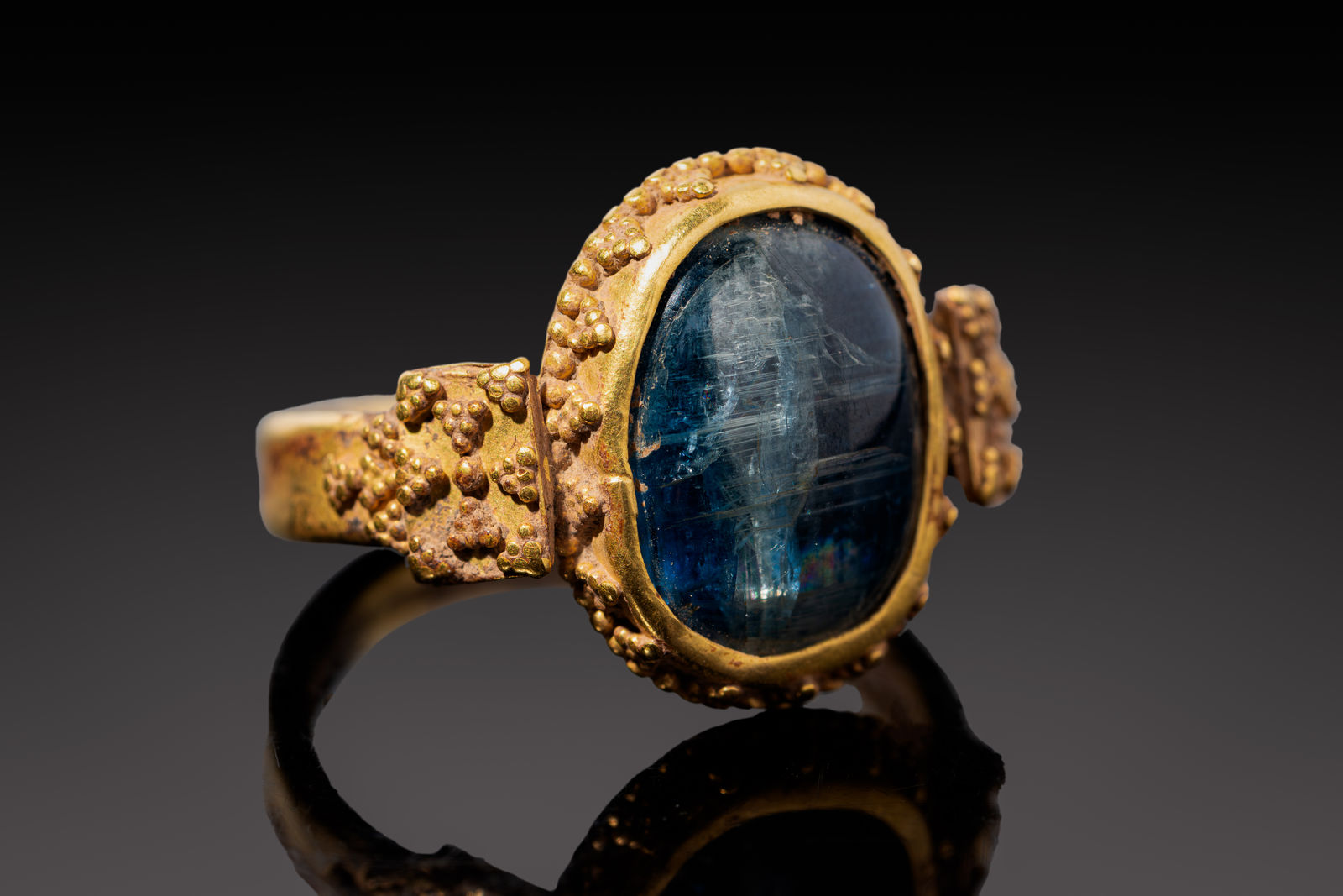 A Byzantine Gold Ring set with a hologram Sapphire Cabochon depicting a standing figure, Circa AD 500 - 800