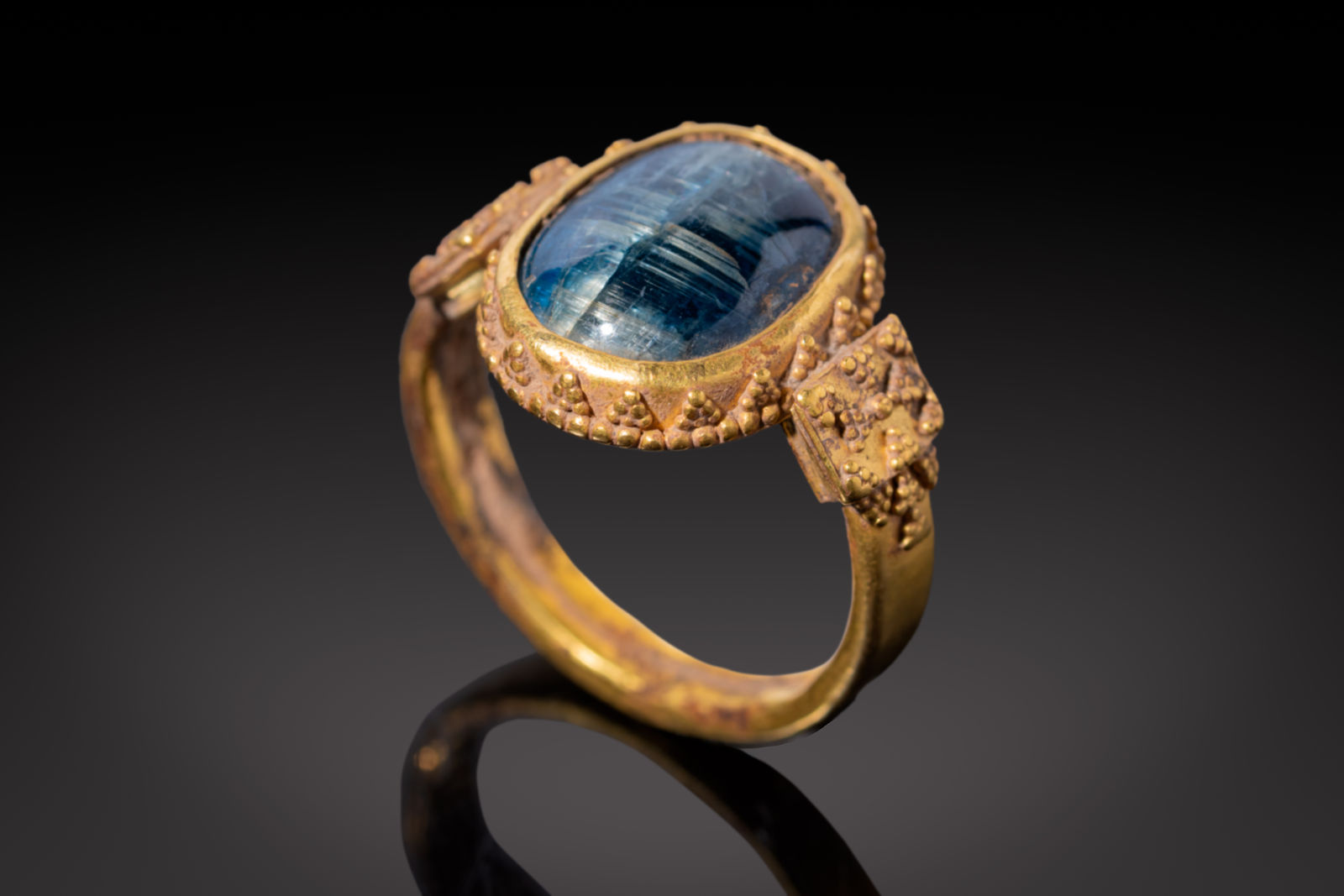 A Byzantine Gold Ring set with a hologram Sapphire Cabochon depicting a standing figure, Circa AD 500 - 800