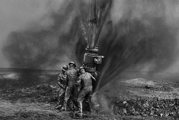 Sebastiao Salgado (b. 1944), Workers Struggle to Remove Bolts, Oil Wells, Kuwait, 1991