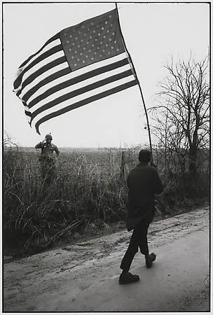 Dan Budnik, Selma to Montgomery March, Will Henry 'Do-Right' Rodgers being saluted by a Sargeant of the Alabama National Guard, Gardner Farm Road, Lowndes County, Alabama, March 23, 1965/ Printed 2002