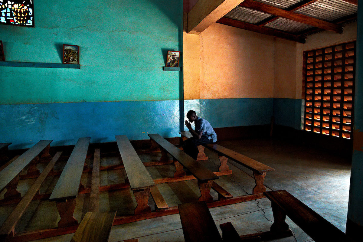 Steve McCurry, A coffee farmer prays in an empty church on the slopes of Mt. Kilimanjaro, Maande Village, Tanzania, 2012