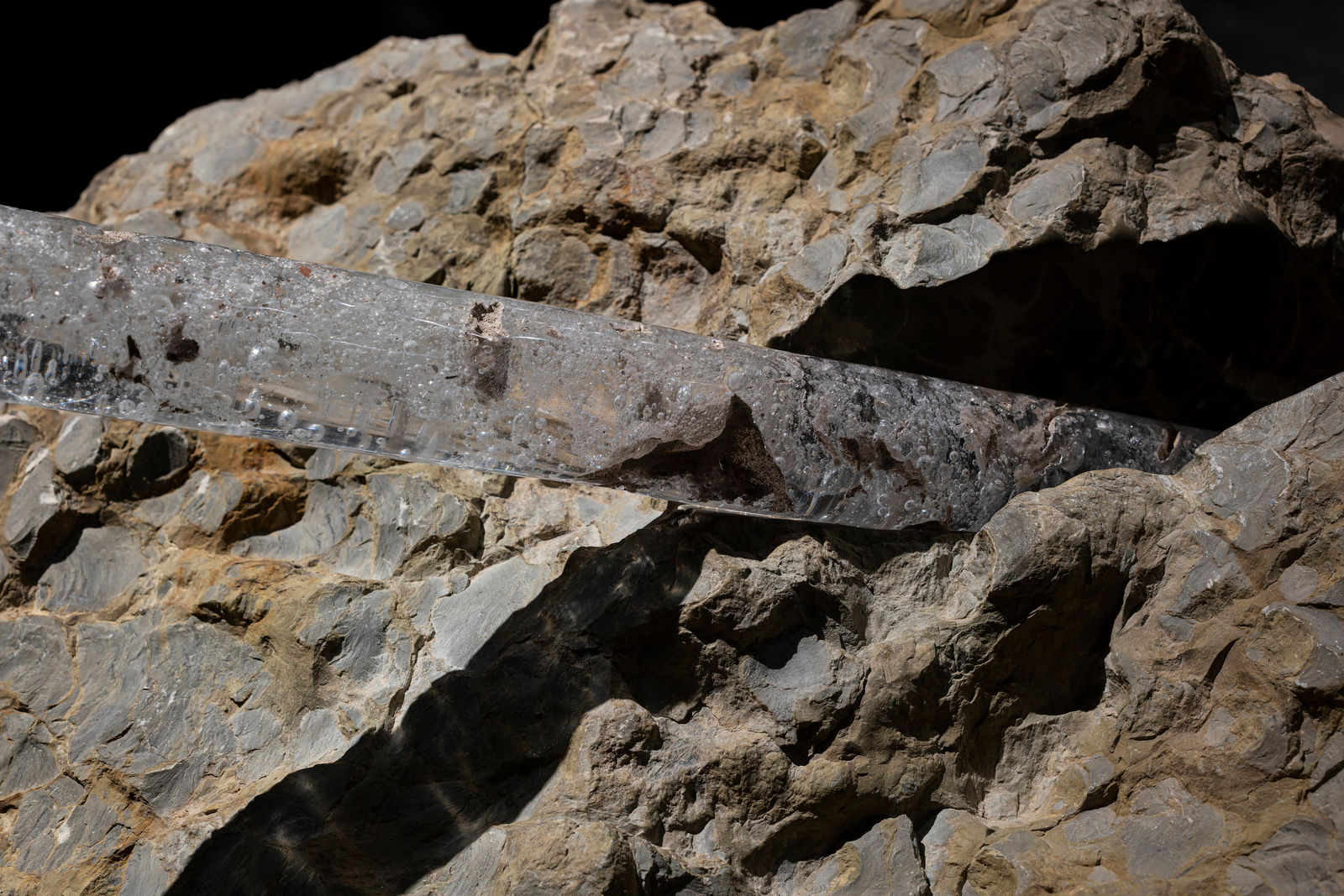 Neha Choksi, Split an ancient riverbed and join with a slant of light churned up from the stones. Hold the dust between stillness. Held across. Don’t wait to cross the bridge, walk the edge now. Sharpen a spear of light, thrust a gurgle of air., 2023-2024