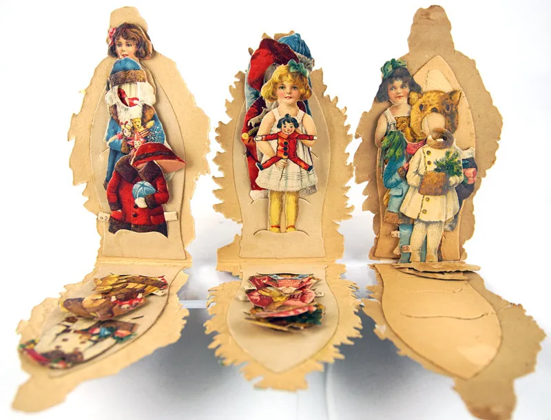 Christmas-themed die-cut paper doll set, (c. 1910)