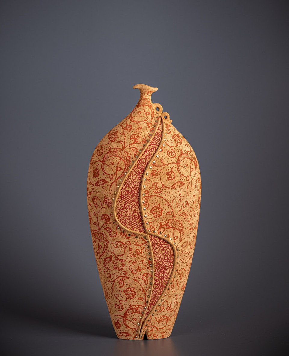 Orange ceramic vessel by artist Avital Sheffer, exhibited at the Rebecca Hossack Art Gallery.