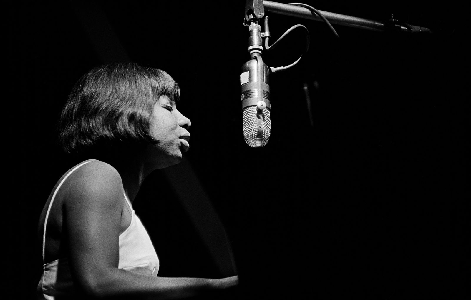 Nina Simone singing in her microphone, white and black photograph by Jim Marshall available at the Rebecca Hossack Art Gallery.