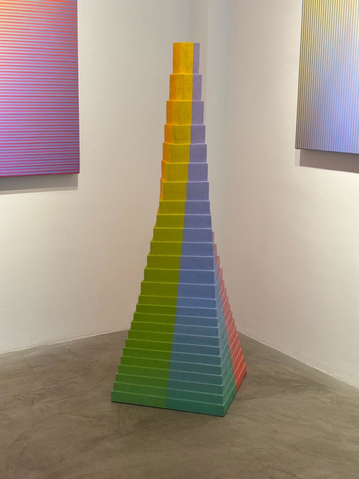 Rainbow, pyramid-like free-standing sculpture by British artist David Whitaker.