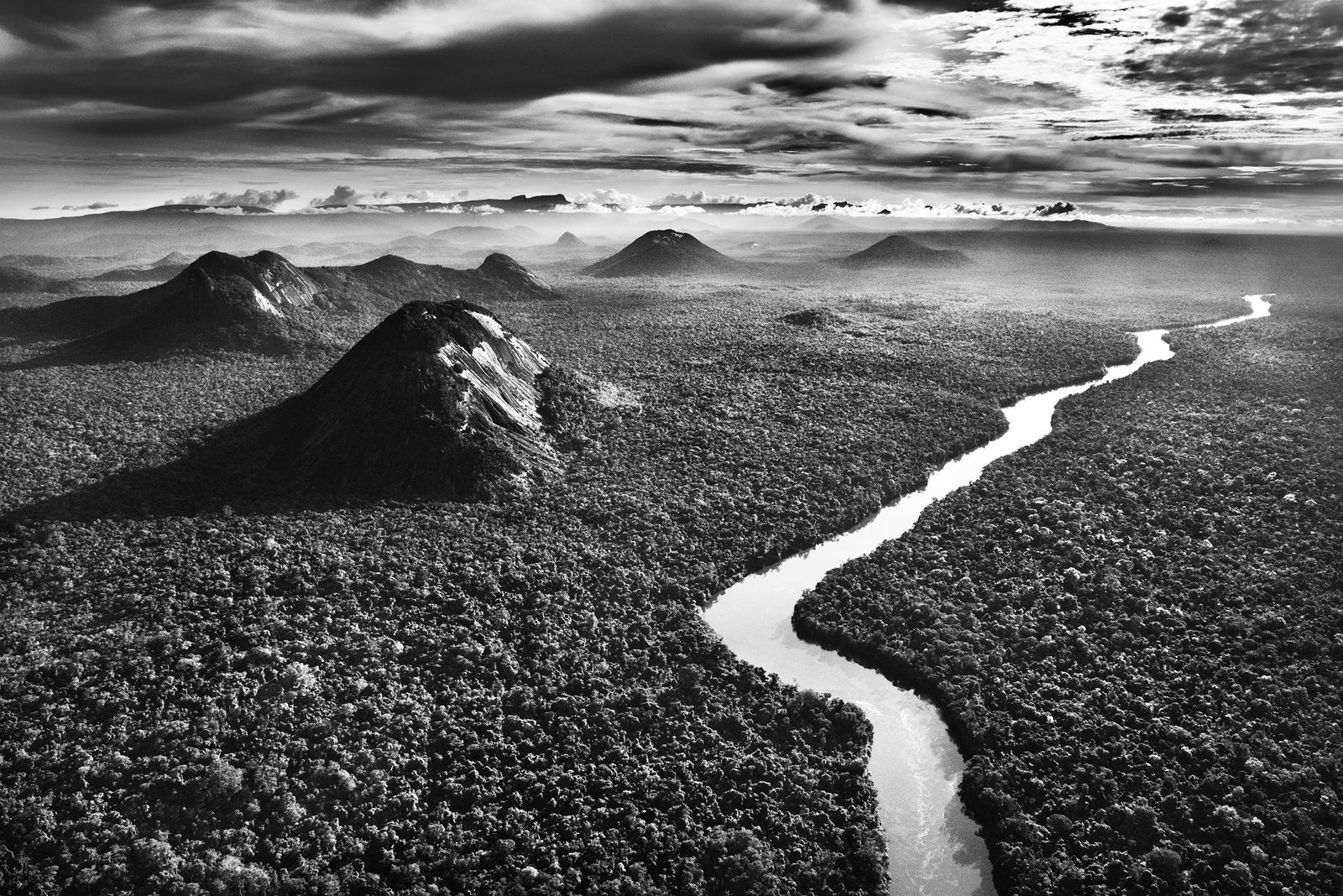 Sebastião Salgado, The Demini River is a tributary of the Rio Negro and flows through the Yanomami Indigenous Territory, bordering the rises of Serra do Aracá Park, State of Amazonas, Brazil, 2019