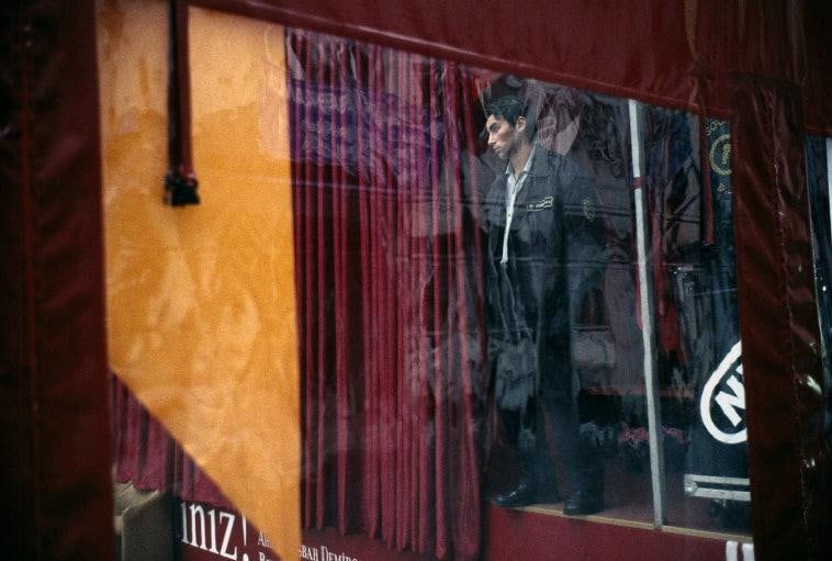 Alex Webb, Istanbul (Man and red fabric), 2003