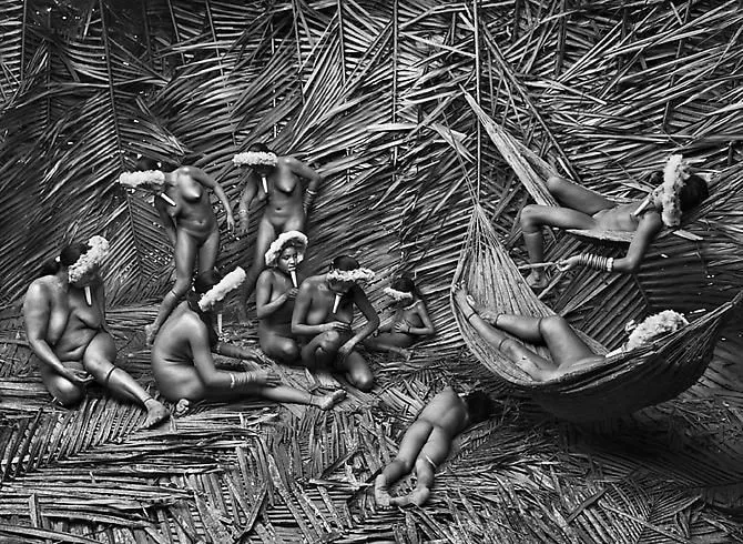 Sebastião Salgado, Women in the Zo'é village of Towari Ypy color their bodies with the red fruit of the urucum. Pará, Brazil, 2009