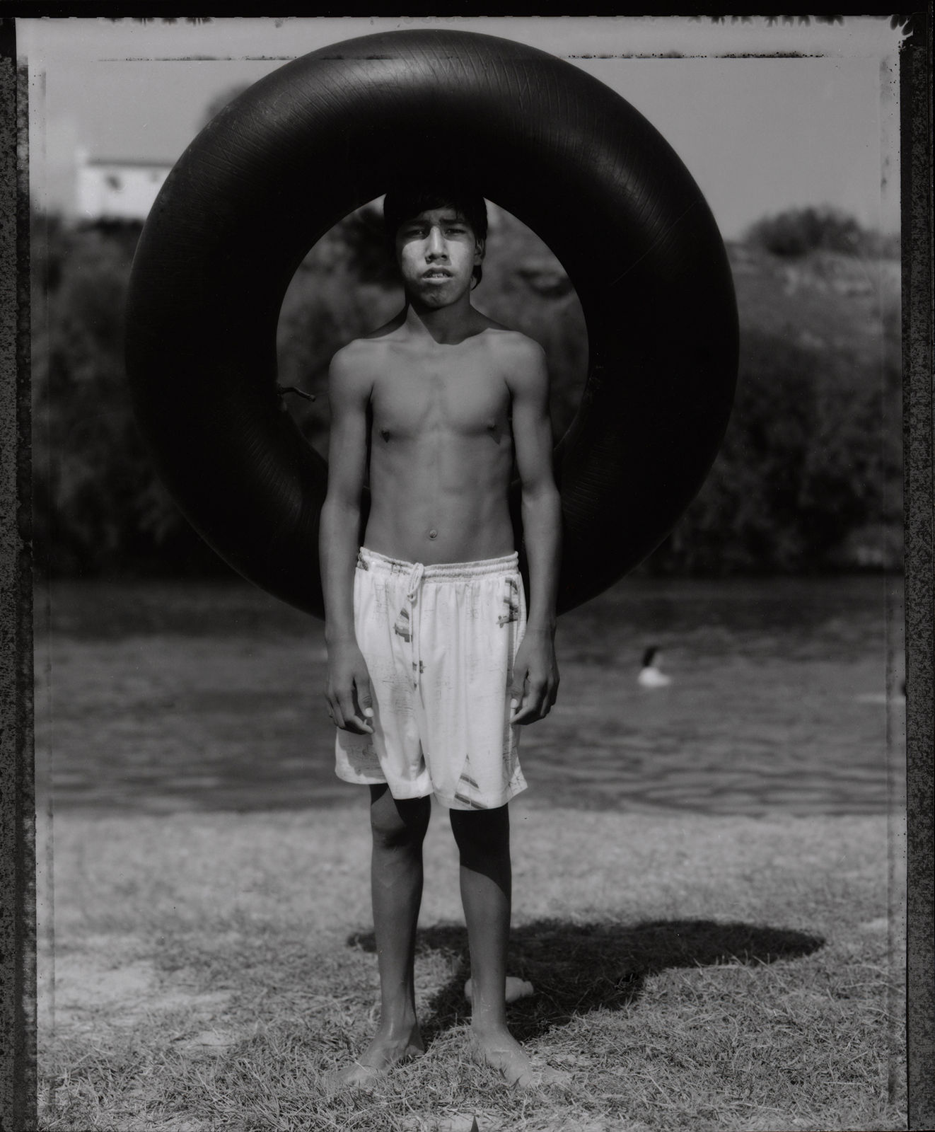 Max Aguilera-Hellweg, Boy with Innertube, Rio Grande, Mexican side, east of Piedras Negras, 1989