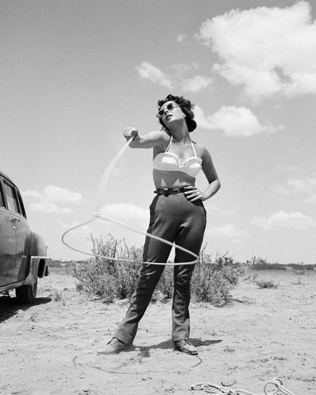 Frank Worth, Elizabeth Taylor with lasso on set of 'Giant', 1955