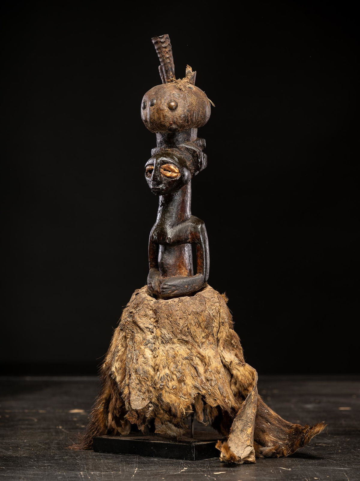 Power figure with cauris inlaid eyes topped with small antilope horns. Kusu People, DRC, 1st half 20th C