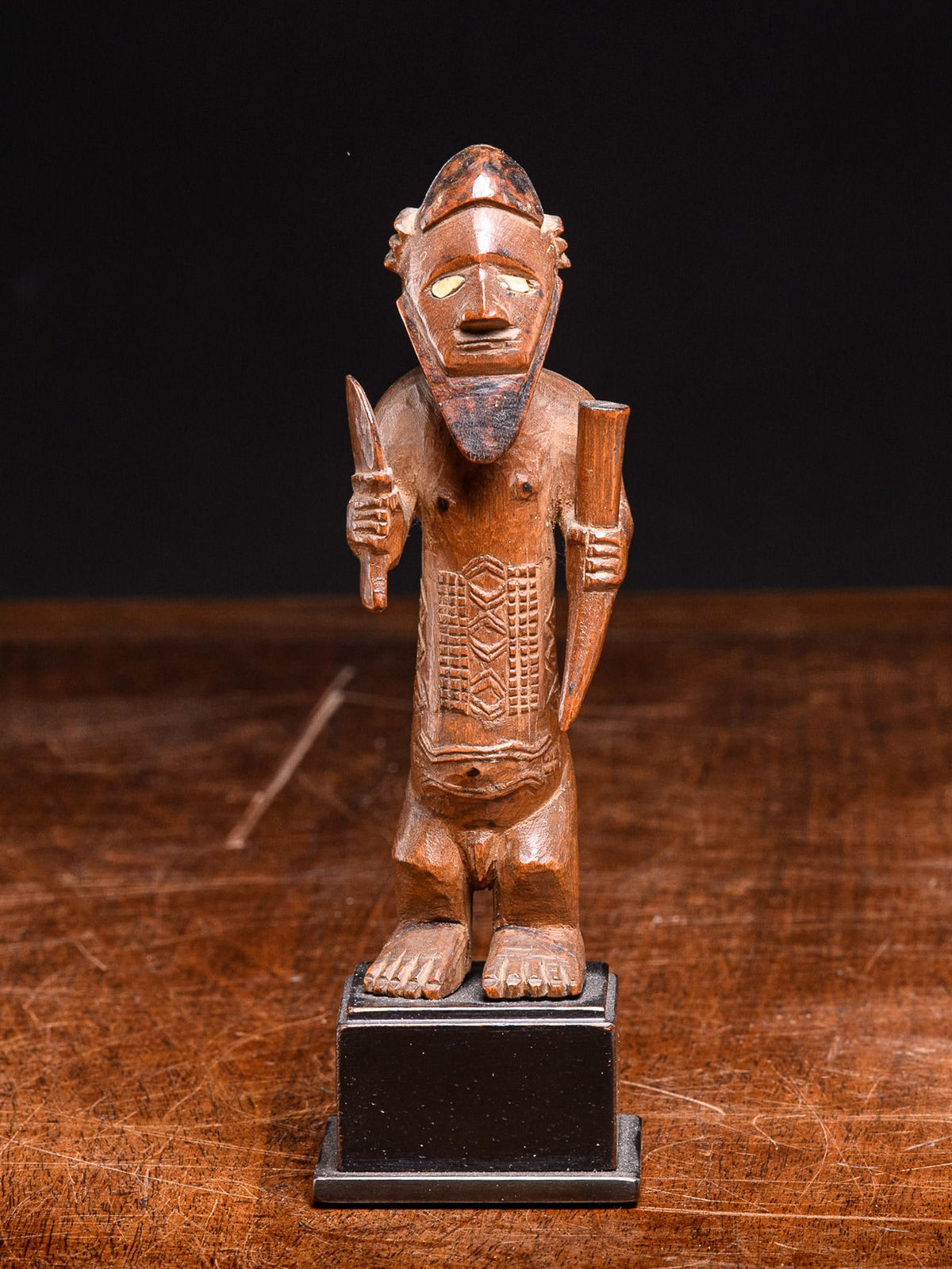 Bembe statue holding a knive and a horn., 1st half 20th C