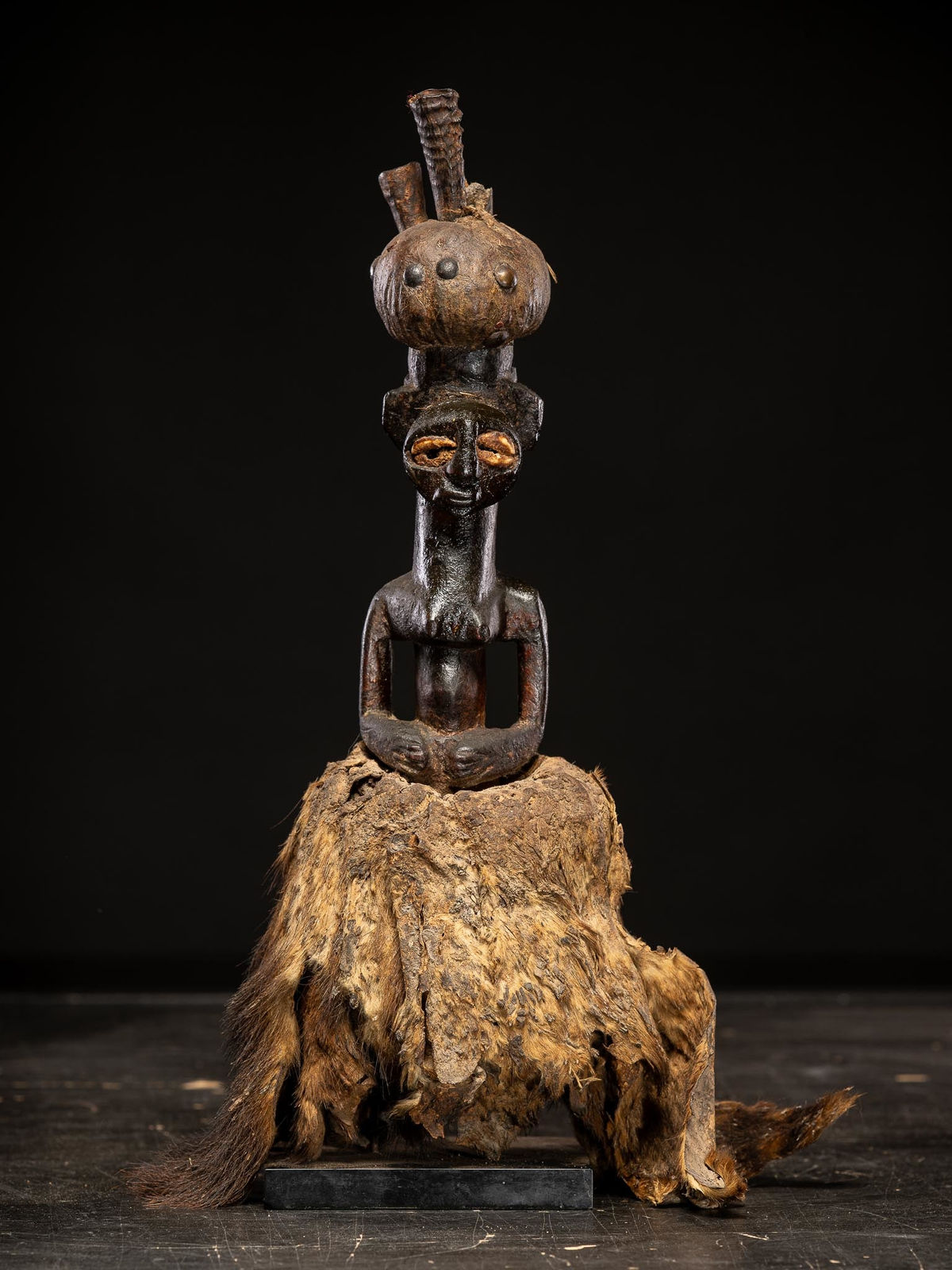 Power figure with cauris inlaid eyes topped with small antilope horns. Kusu People, DRC, 1st half 20th C