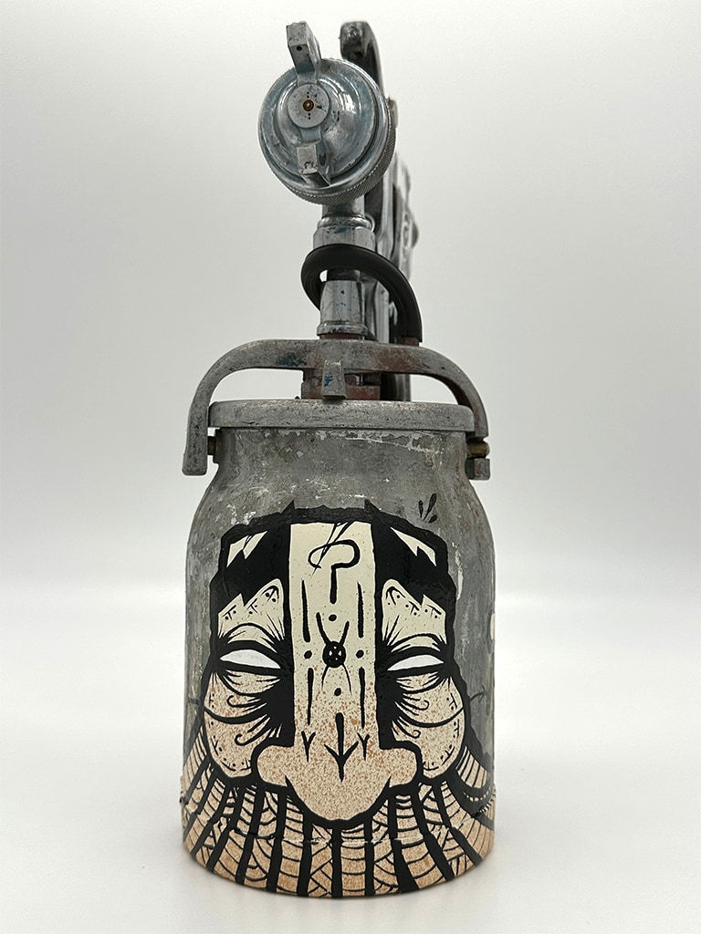 metal spray paint can decorated with GATS figure