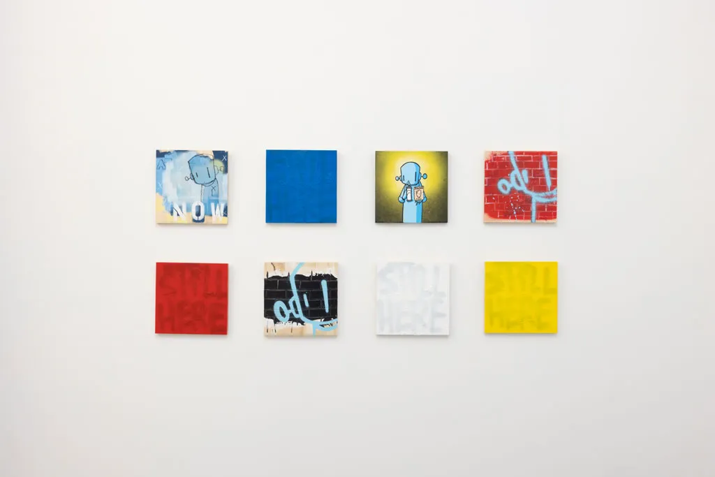 grid of small colorful pieces by Chris RWK on white gallery wall