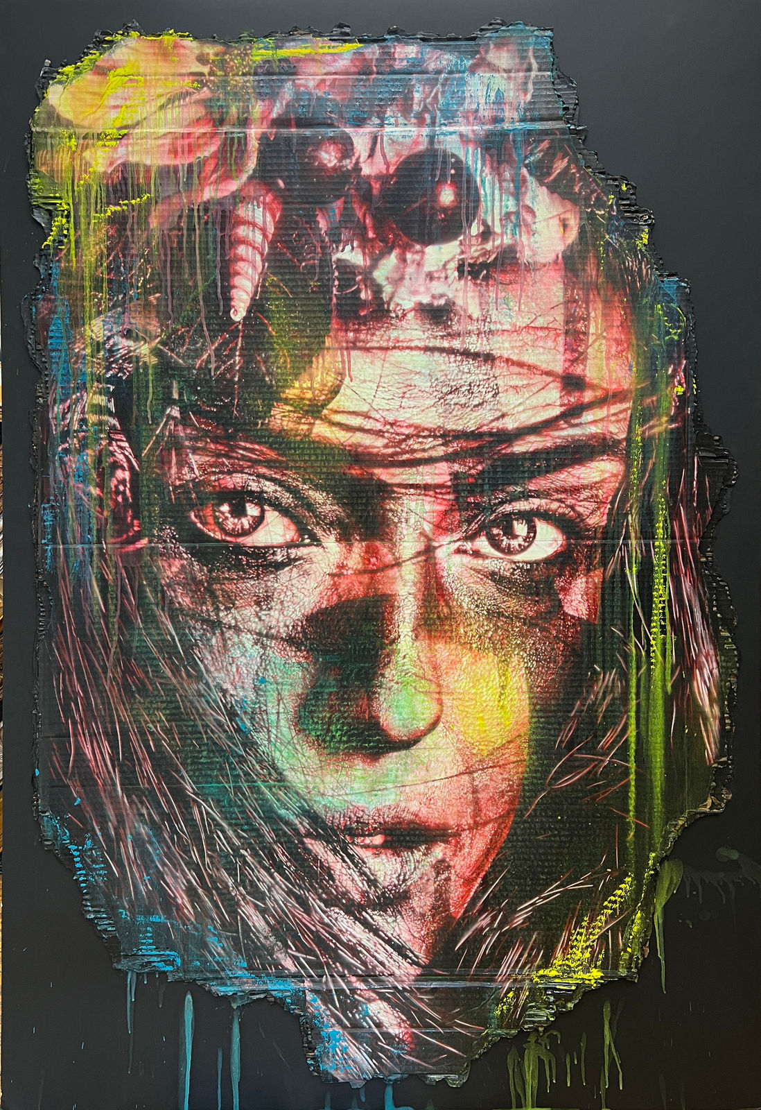 woman's face painted in red, yellow and blue over a black background