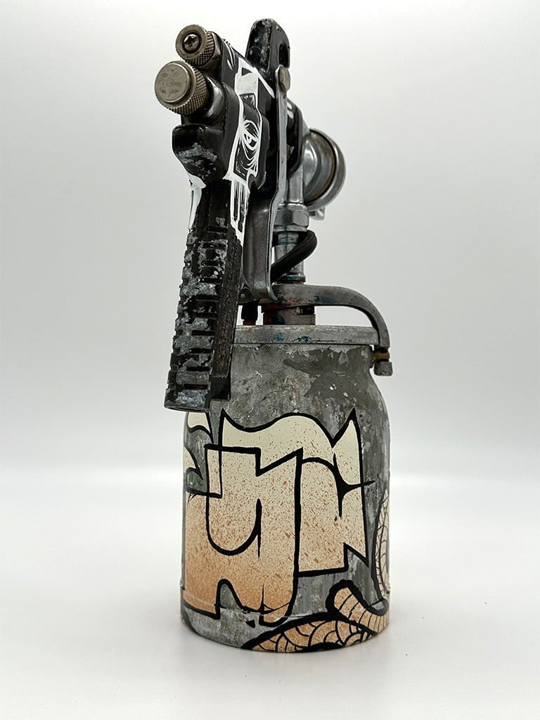 metal spray paint can decorated with GATS figure