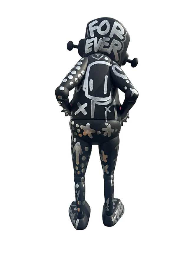back view of a black and silver robot statue covered in designs