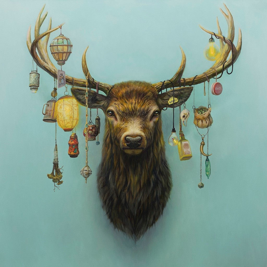 a mounted deer head with different ornaments hanging from its antlers