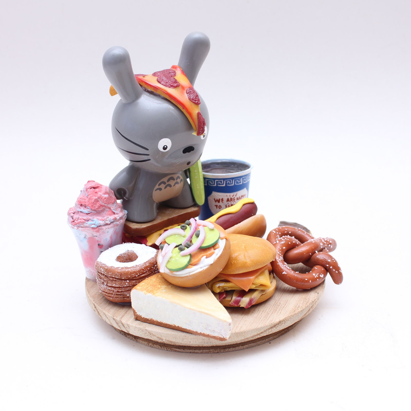 Vinyl Totoro figure with a platter of classic NYC food